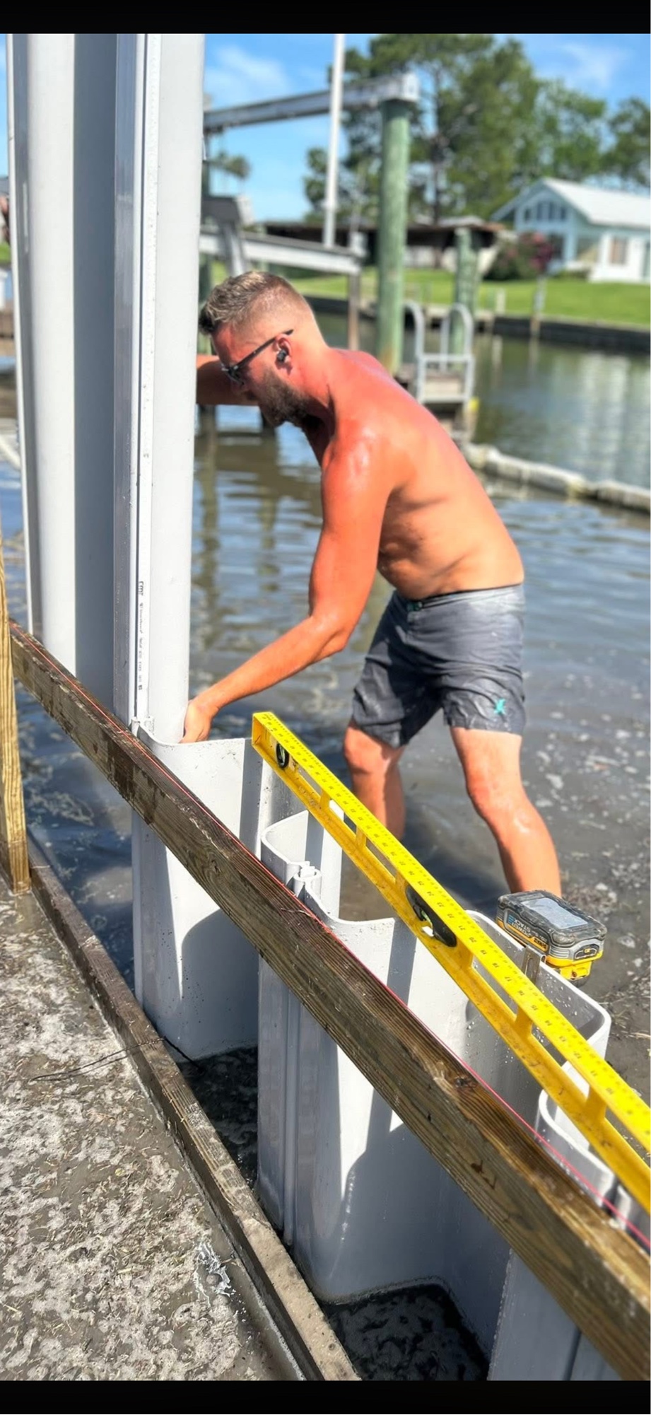 Britt Grey hands-on installing vinyl seawall panels in the water