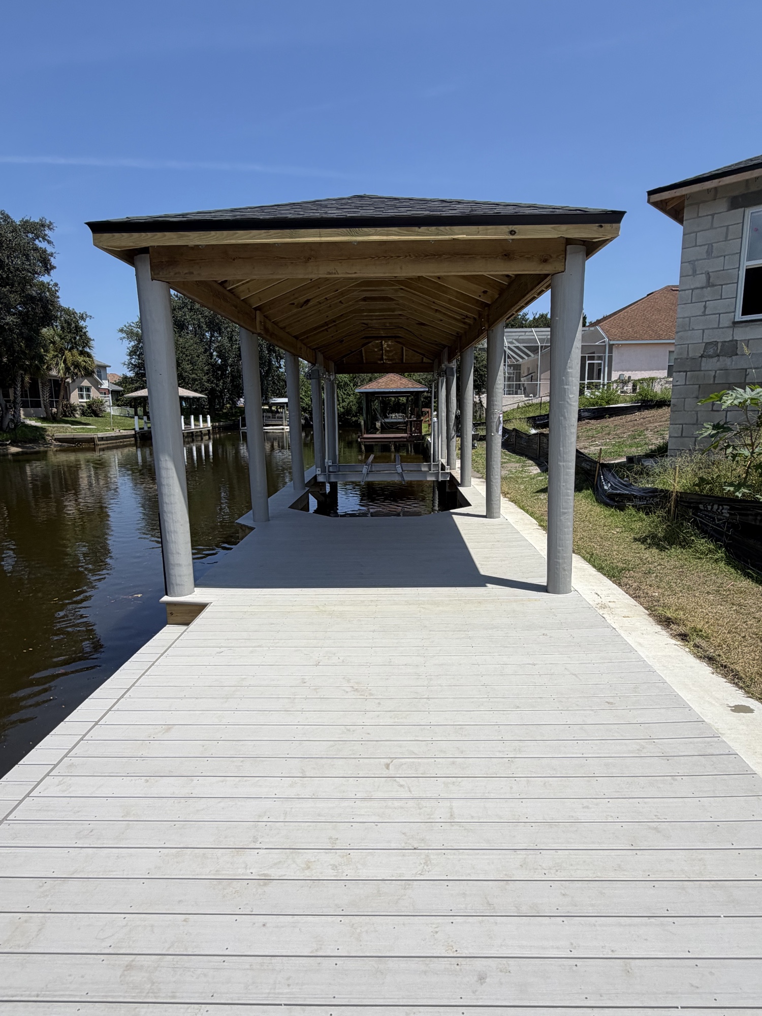 The Mammoth Dock — 130ft covered dock with banding roof, white composite decking, Palm Coast FL