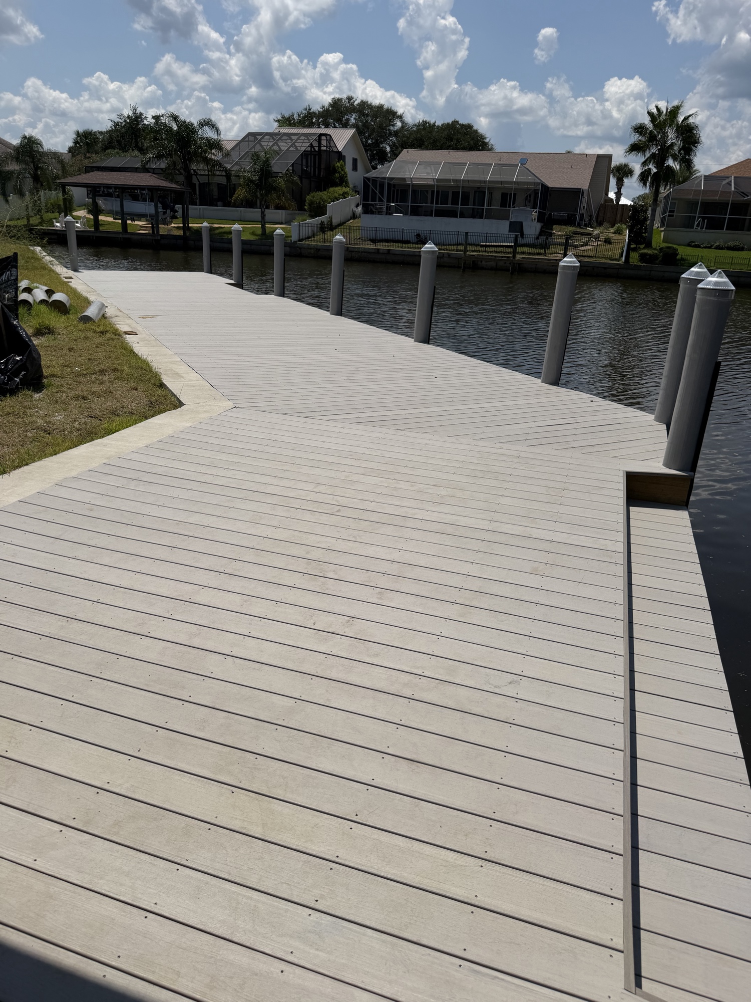 Mammoth dock wide angle — fresh composite deck, white pile caps, seawall cap