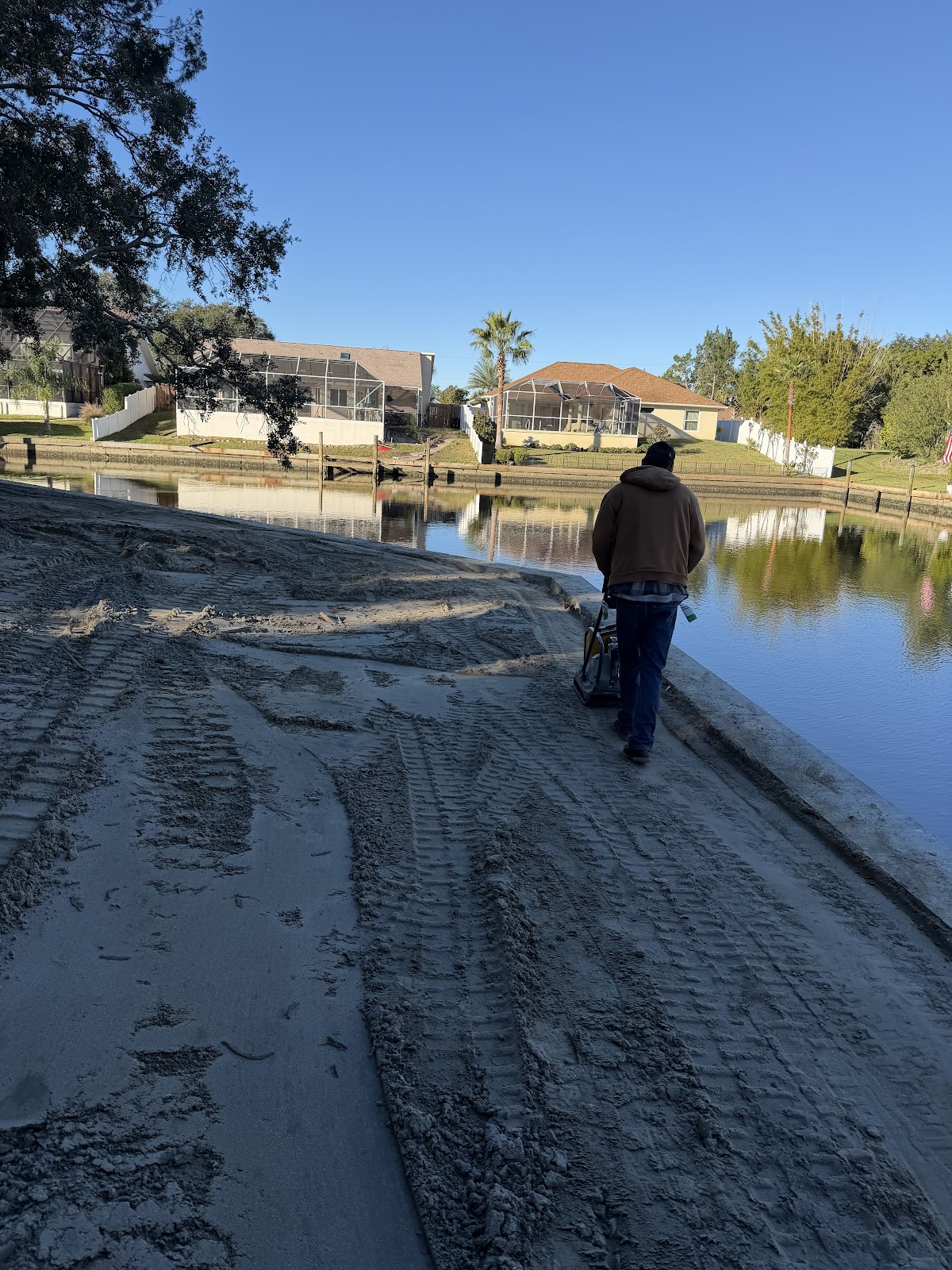 Crew working fresh seawall cap along Florida intracoastal canal
