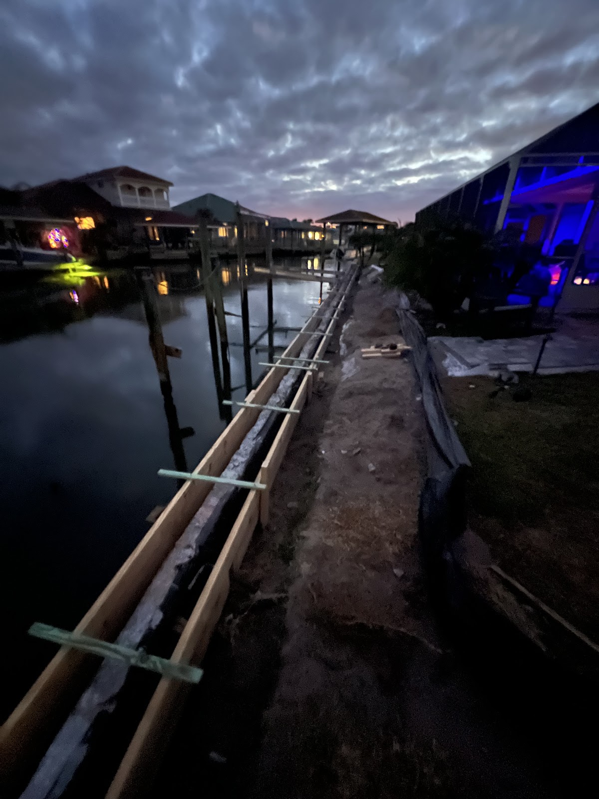 Seawall form work at dusk on Florida canal
