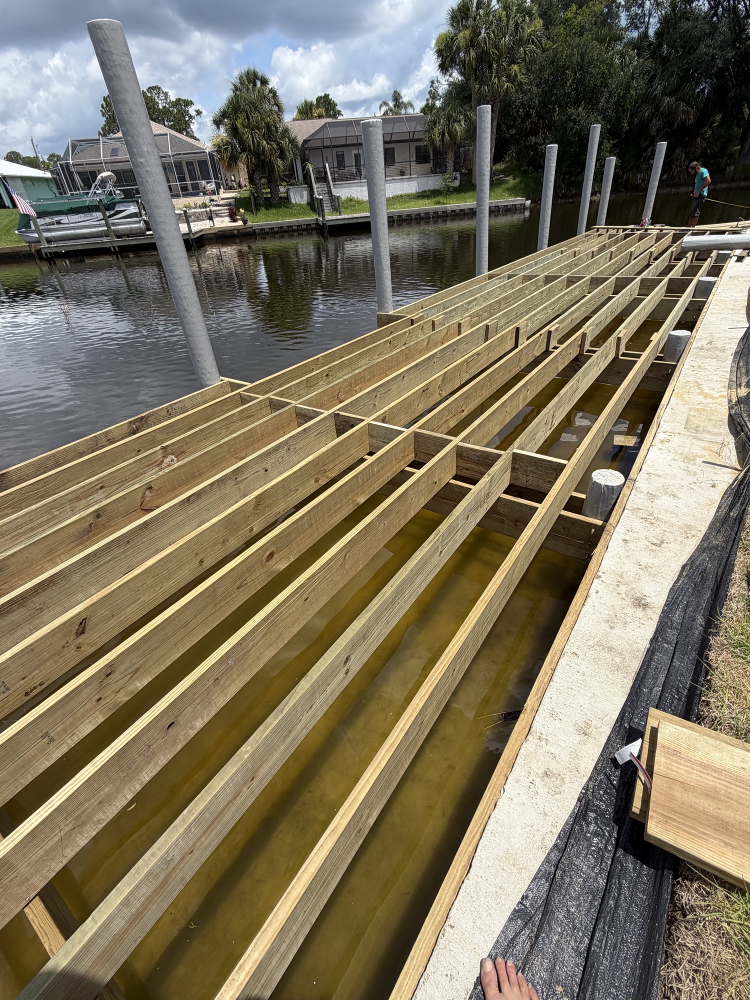 Superior dock frame construction — pressure treated lumber over Florida canal