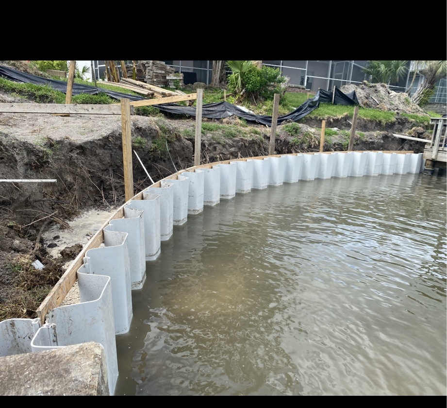 Curved vinyl sheet pile seawall installation in progress, Flagler County FL