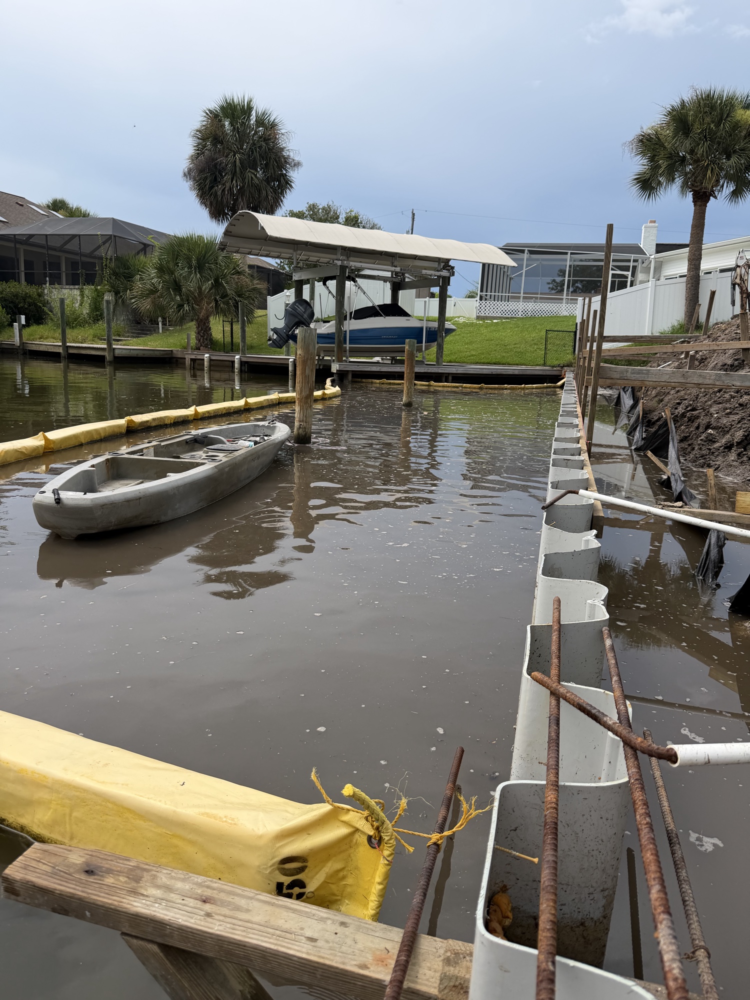 Vinyl sheet pile seawall installation with work boat